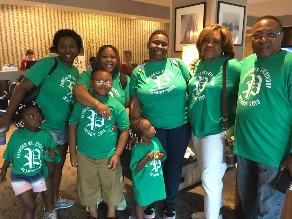 Family members together in matching green Patrick reunion shirts